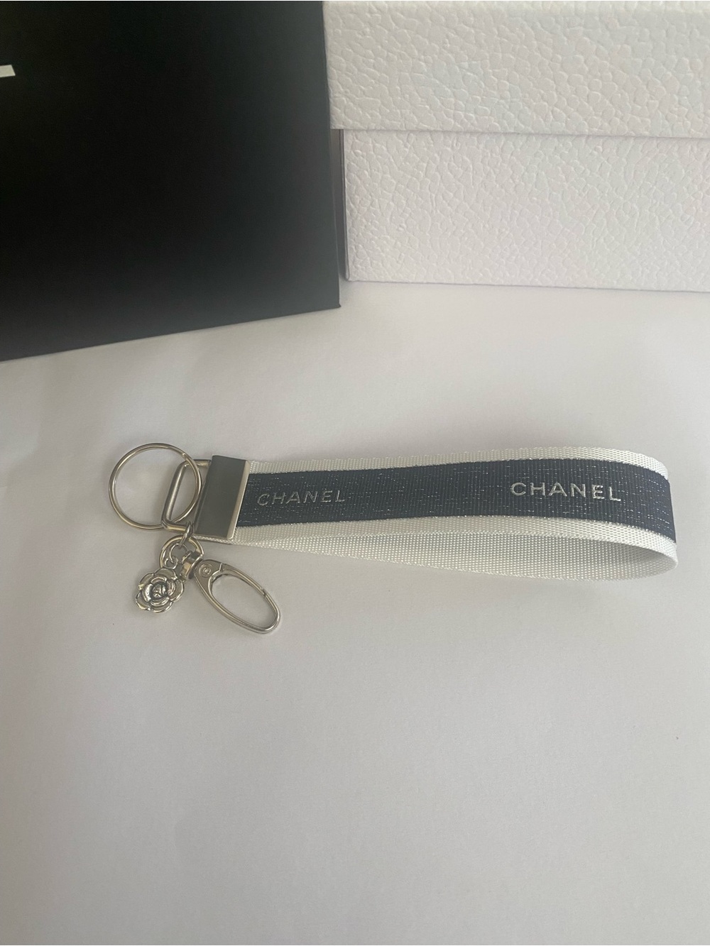 CHANEL Ribbon Shimmering Navy and White Key Wristlet  with Camellia Charm